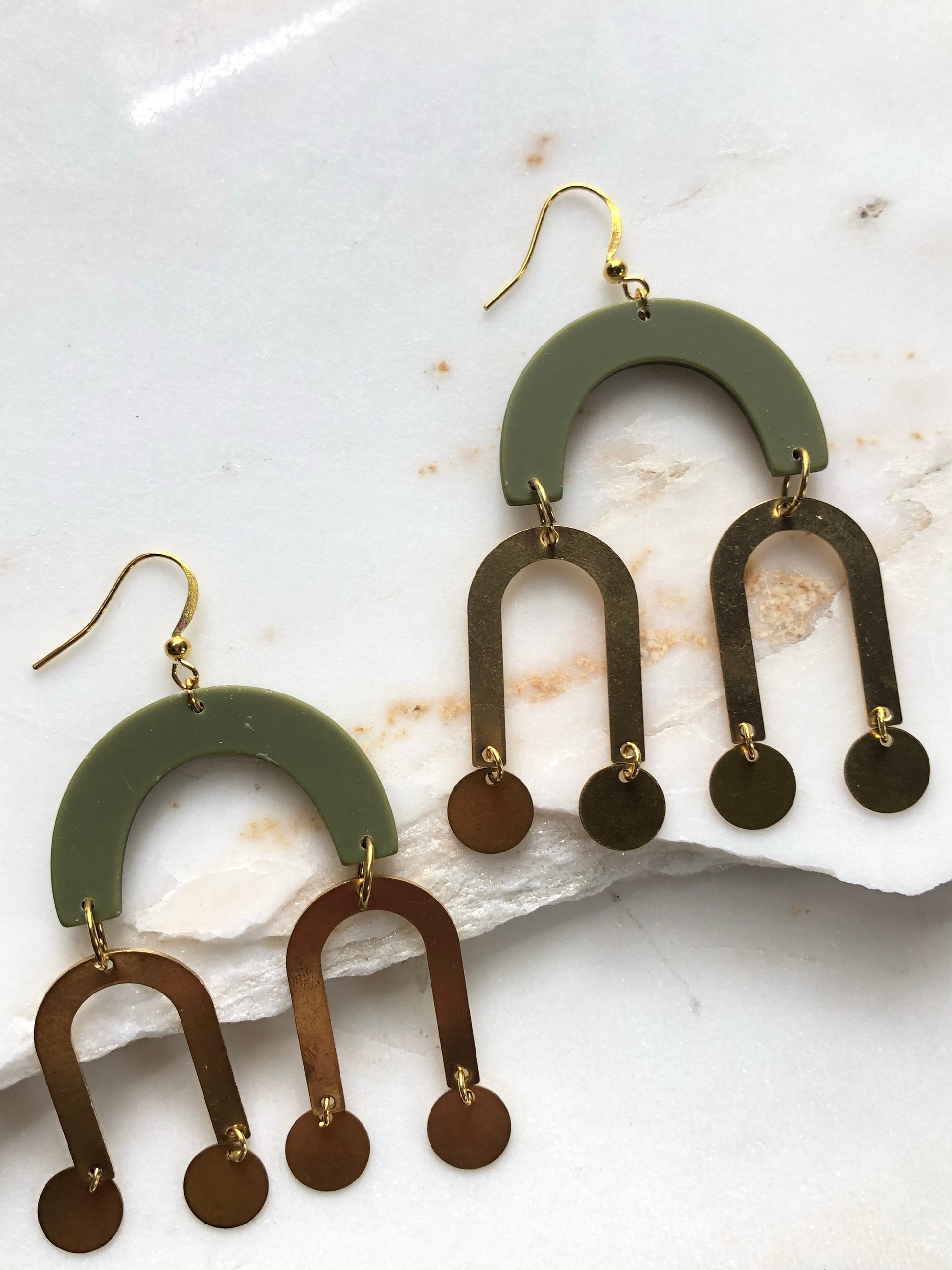 Green acrylic arches with brass arches and brass circles underneath