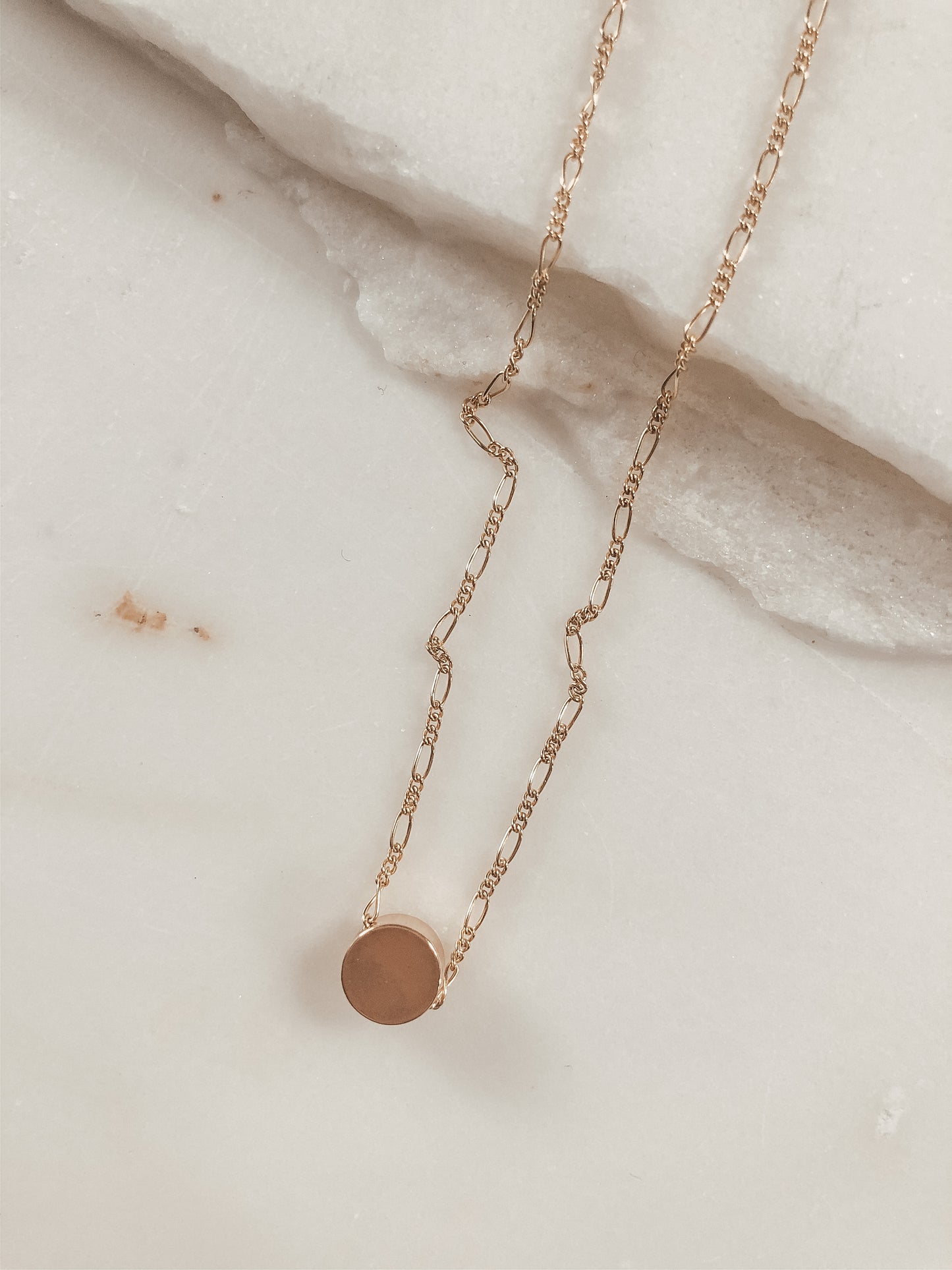 small gold bead on a gold Figaro chain