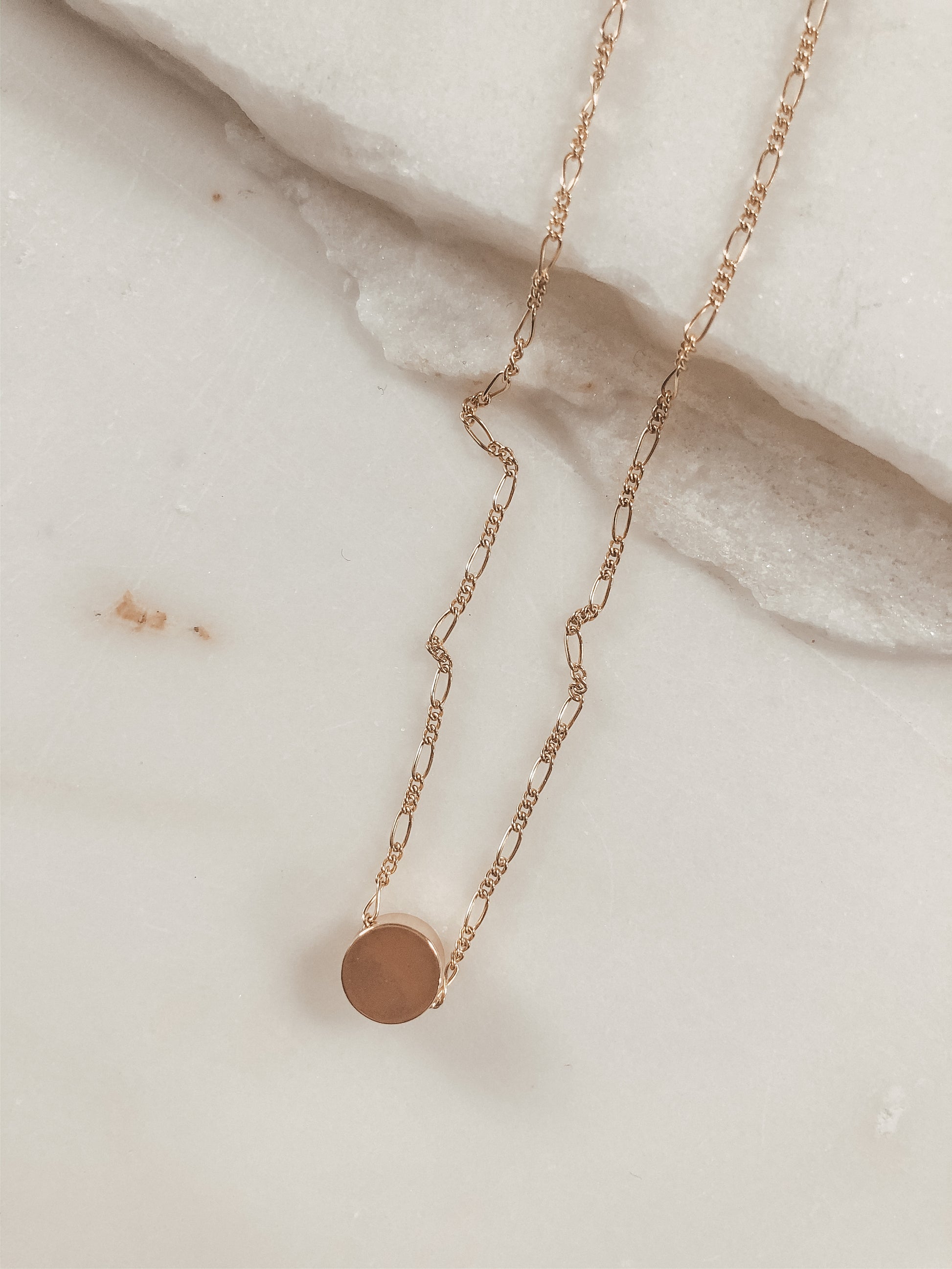 small gold bead on a gold Figaro chain