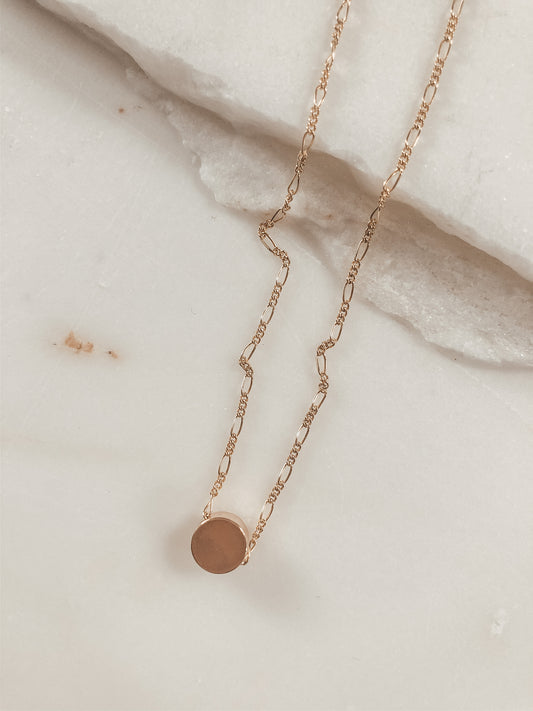 small gold bead on a gold Figaro chain