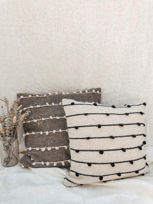 woven throw pillow cover with a line and dot design