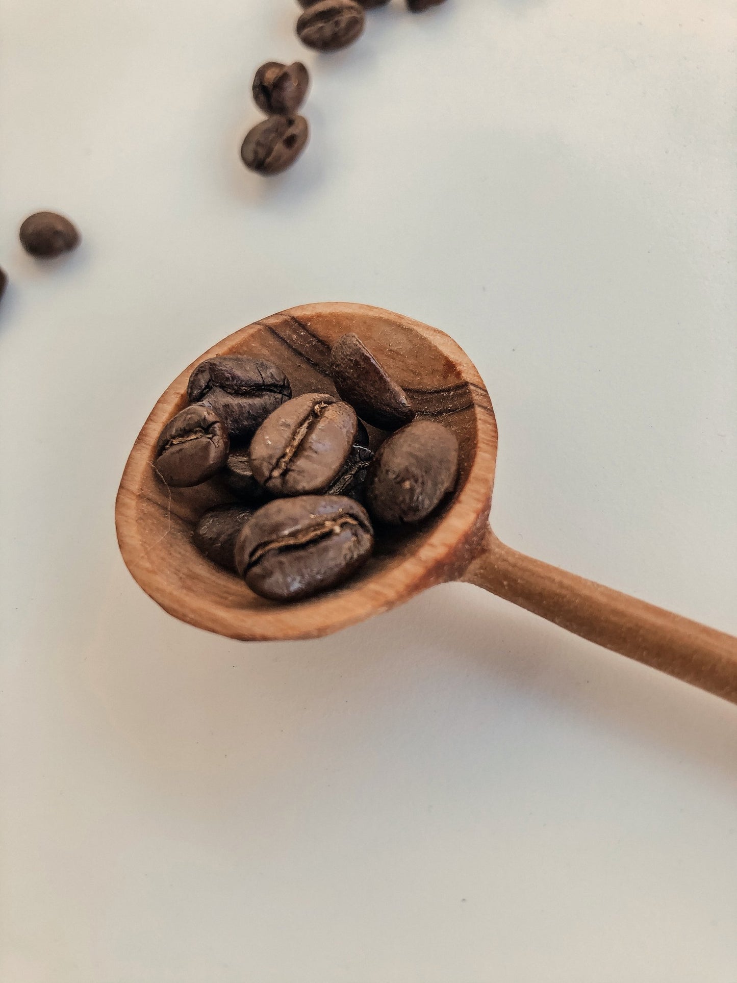 hand carved wood spoon with bone detail on the handle