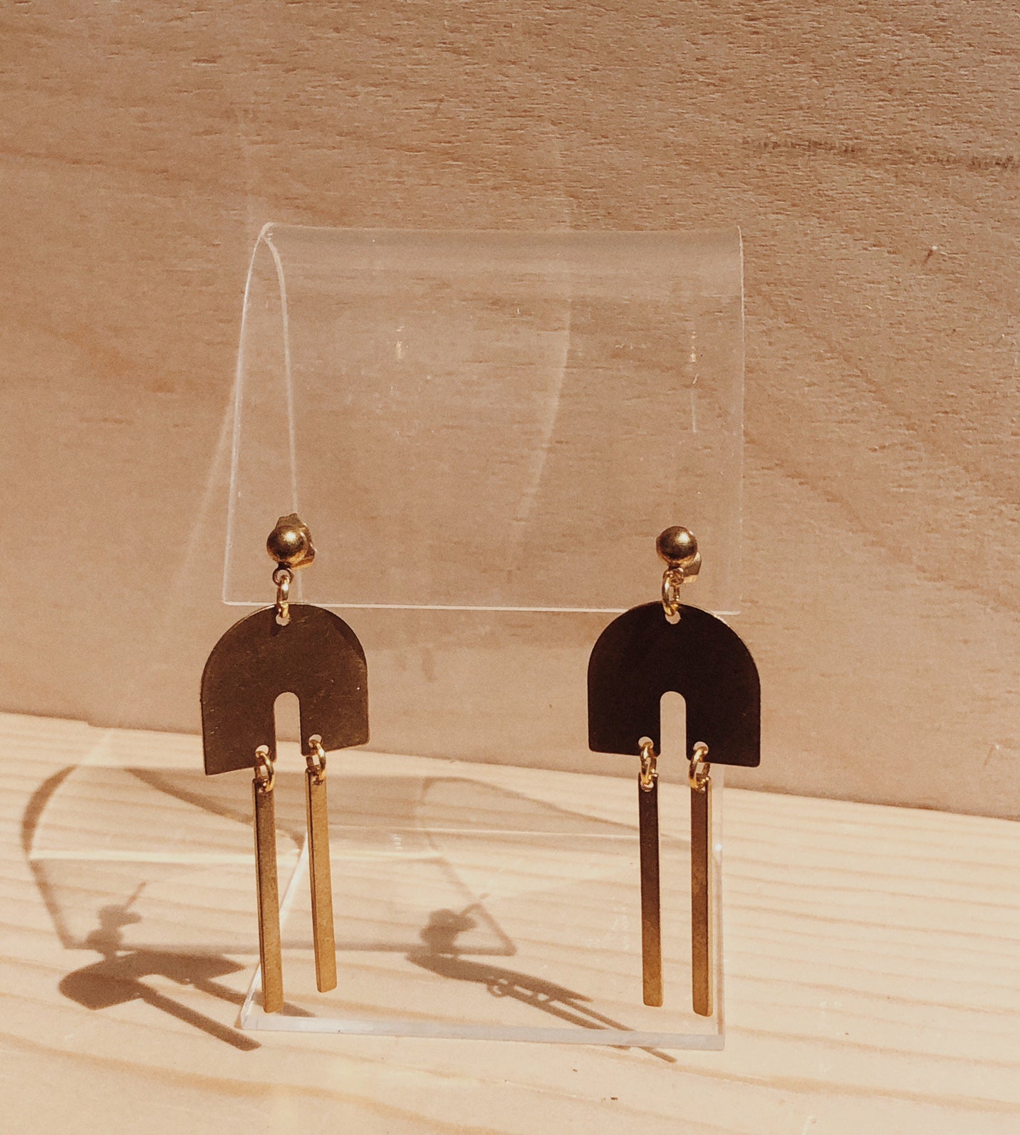 Brass arched earrings.