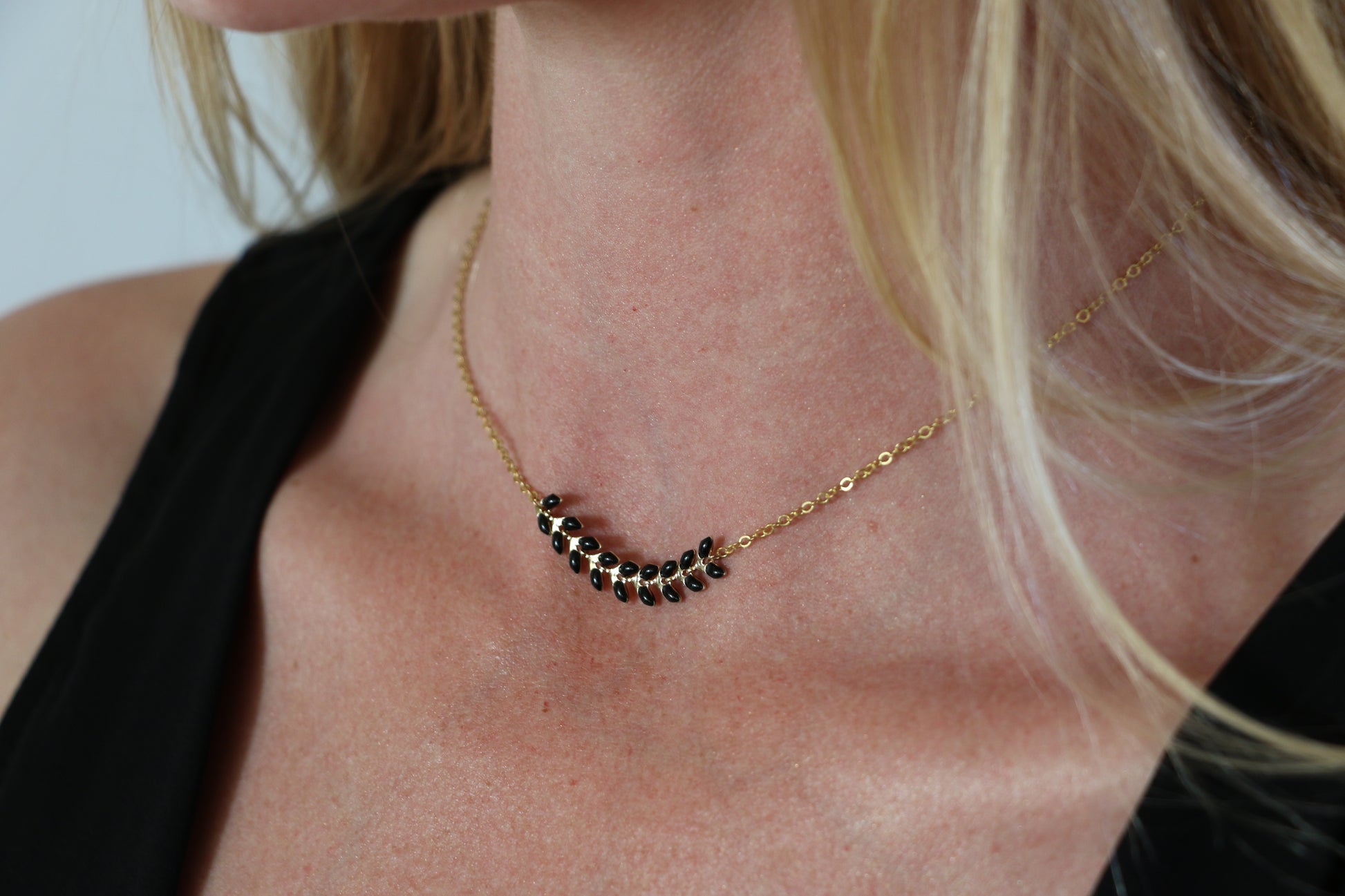 Black detail on a gold chain necklace
