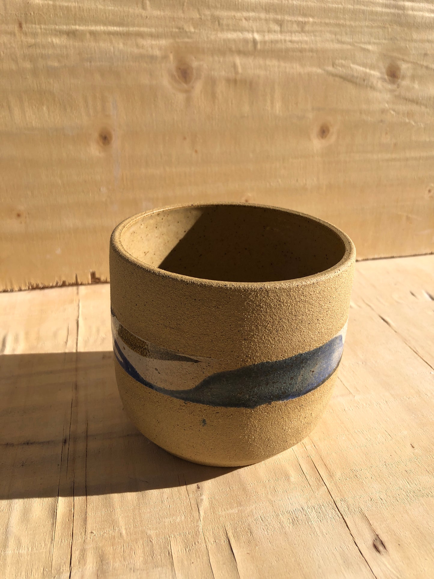 Planter with speckled clay and white, blue and brown watercolor styled design